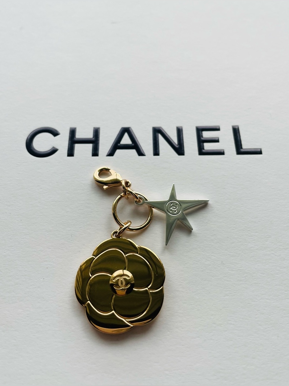 CHANEL Gold 2025 Limited Edition Holiday Camellia Flower with Silver Star Charm